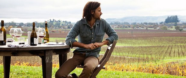 Picture of Guy Sitting in a Field Wearing a Denim Shirt