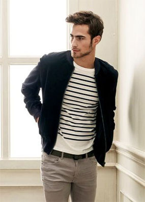 Example of a neutral outfit with grey jeans, black and white striped t-shirt and navy jacket