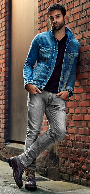 man wearing grey jeans with denim jacket