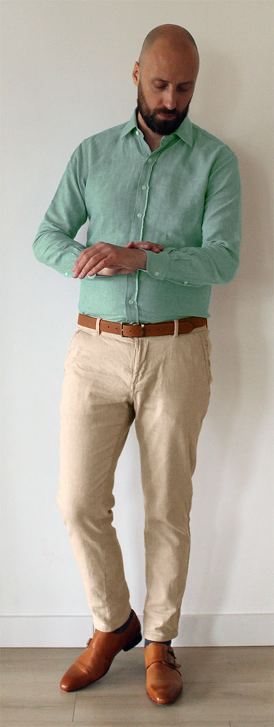 Man wearing mint green dress shirt with khaki pants