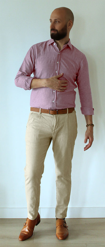 Man wearing pink dress shirt with khaki pants